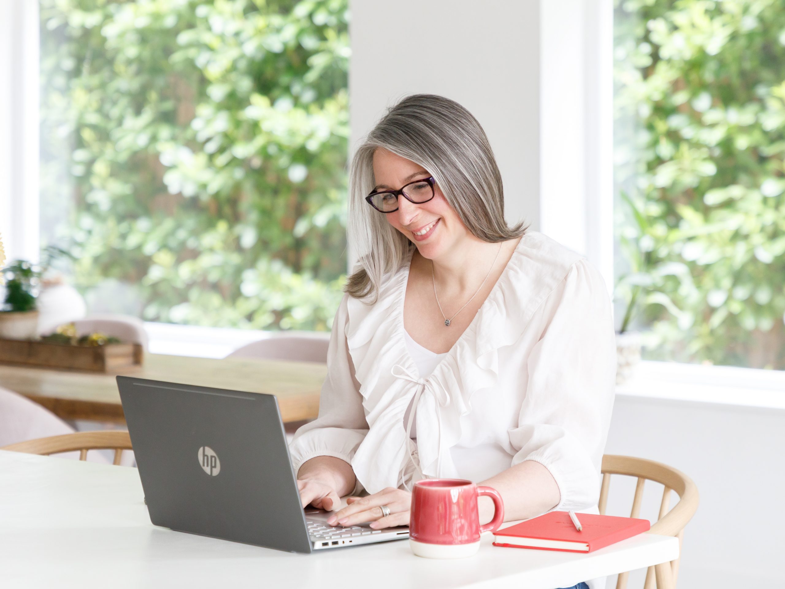 Janet Padfield sat to a laptop in a onsultation